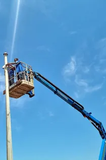 Technician using an elevated platform to install CCTV cameras in Cape Town